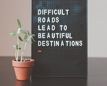 Sign saying Difficult Roads Lead To Beautiful Destinations
