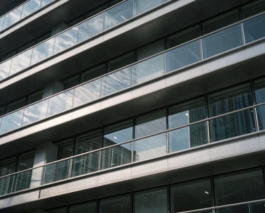 Close-up of a modern architectural structure made of steel and glass, catching the sunlight. The composition is abstract and professional, highlighting innovation.