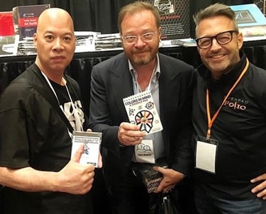 RayRay Lum and Brett Barry  holding magic trick products like Colors in Mind doodle pad.