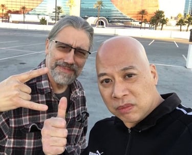 Ray and Chance wolf posing in a Las Vegas parking lot with the Rio Hotel in the background.