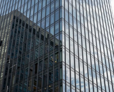 Modern abstract architectural detail of a glass building in a Brazilian financial center, representing corporate strength and legal security.