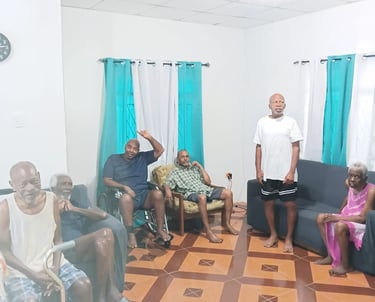Elderly people resting and socializing in a communal living room at a senior care home.