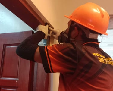 “Dumaguete pest control technician installing termite bait system to protect home from infestation, 