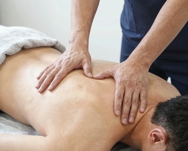 A warm, inviting chiropractic clinic room with soft green accents and natural light.