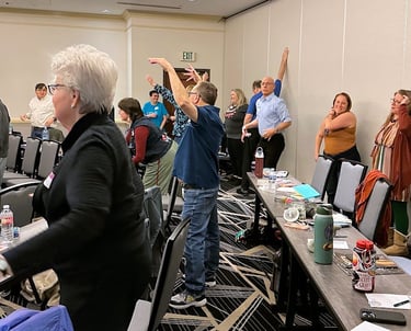 Conference attendees moving for an exercise at HCC 2026. Photo by Cheryl V