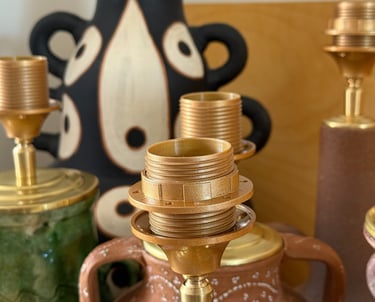 Collection of vintage ceramic lamps and brass fixtures with artistic pottery bases.