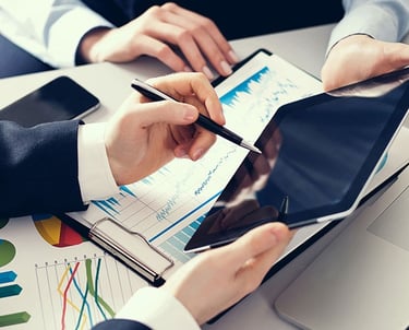 a man and woman working on a laptop computer