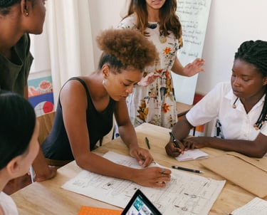 a group of people sitting around a table brainstorming ideas
