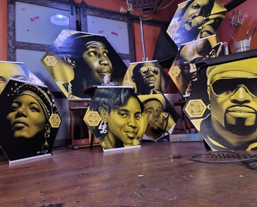 Hip hop icons painted of boards for a school mural.