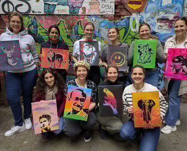 Street art workshop in Hamburg with group holding stencil artworks, Graffiti Workshop mit Teilnehmern und eigenen Kunstwerken