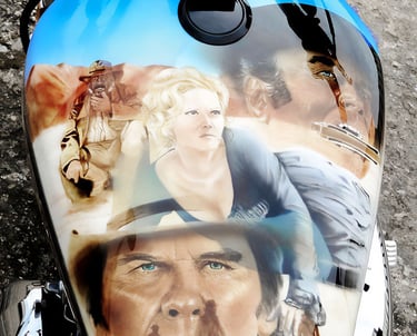 Custom airbrushed motorcycle gas tank featuring portraits of characters from classic Western films.