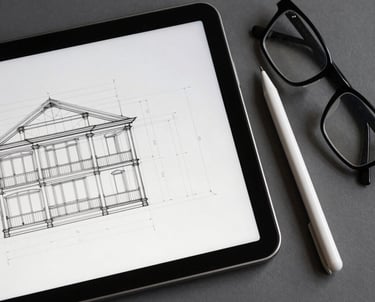 A top-down shot of a digital tablet showing architectural wireframes. Next to it, a stylus and a pair of professional glasses. Clean and sophisticated.