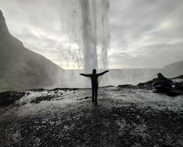 a person standing in front of a waterfall