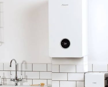 Modern white wall-mounted combi boiler installed in a bright kitchen.