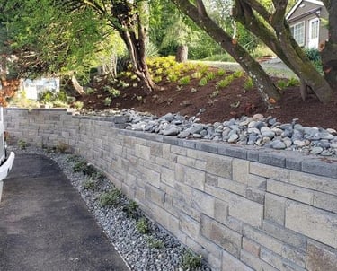 Modern tiered block retaining wall for slope management and erosion control.