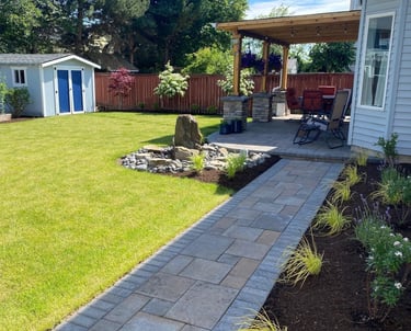 Beautifully maintained residential backyard with a stone walkway