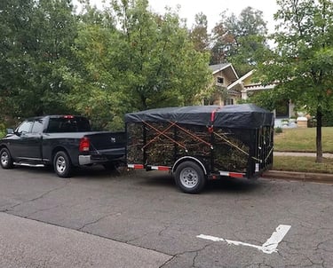 Professional truck and caged trailer hauling yard waste