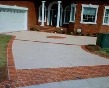 a brick house with a driveway with a driveway with brickwork