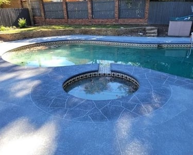a pool with a hot tub and a pool