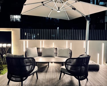 Cozy outdoor lounge area with umbrella and ambient lighting.