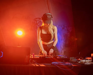 A professional female DJ mixes music on a Pioneer controller under vibrant red club lighting.