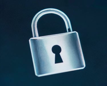 A close-up of a secure, shining padlock icon on a digital screen, emphasizing data protection and safety, in dark charcoal blue and deep teal tones.