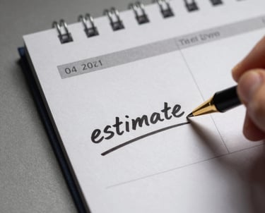 Team collaborating around a table with laptops and notes.