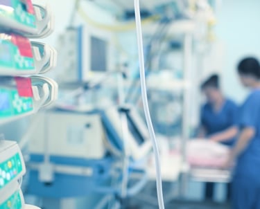 ICU nurses in Saudi hospital critical care unit with advanced monitoring equipment.