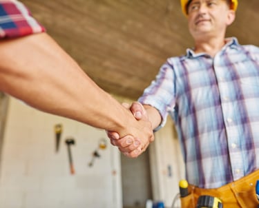 handyman shaking hands with a satisfied client after completing work in Auckland