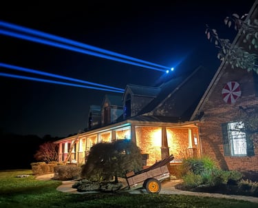 Beams of light shining off of a house