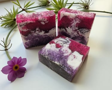 Handmade botanical soap bars with pink and purple swirls and poppy seeds, natural artisan soap made