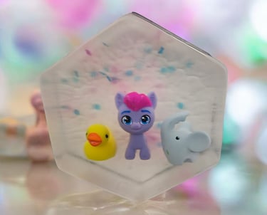 Handmade kids soap bar with colorful toy pony, rubber duck, and elephant inside, fun surprise soap
