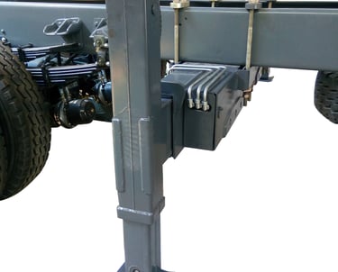 Truck's backside featuring steel plate and rear outriggers for crane support.