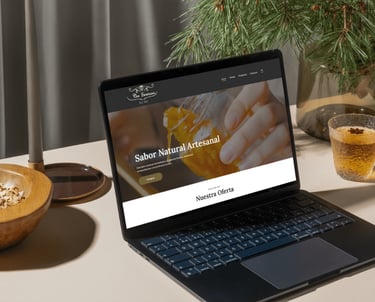 a laptop computer sitting on a table with a bowl of food