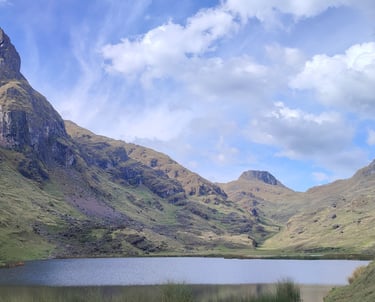 a mountain scene with a lake and mountains in the background