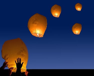 Lamps floating in the sky.