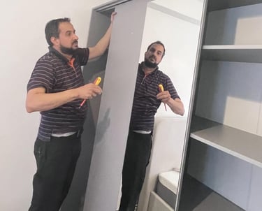 a man a man assembling wardrobe
