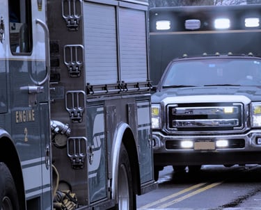 "Fire engine truck and emergency response vehicles on street during call"