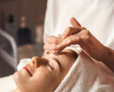 An image of a woman receiving a face massage