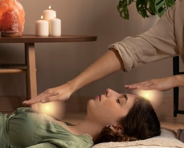 An image of a woman in a green top laying on a pillow on the carpet receiving Spiritual Healing.