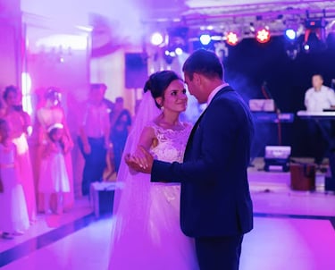 a bride and groom are standing in front of a band of people