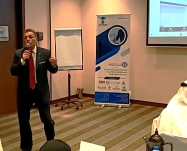 Major General Ayman Syedelahl wearing an elegant suit, providing a training course in AbuDhabi, UAE