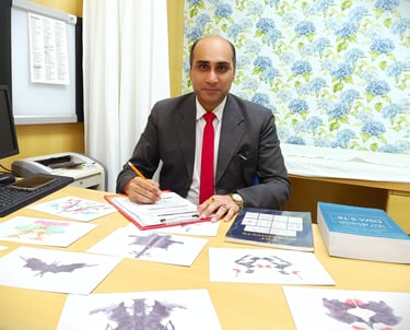 Dr. Prabal Frank Nandwani, Licensed Clinical Psychologist and Corporate Trainer, sitting at his desk