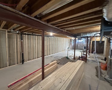 Basement Framing with new lumber on ground ready to install