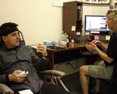 picture of healer performing a biofeedback therapy with a seeker 