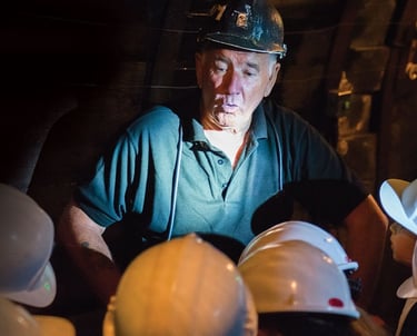 a welsh miner chatting to visitors