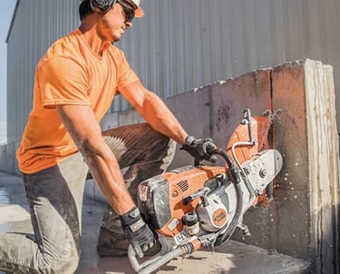 a man in a helmet is cutting a concrete block with ts800 saw