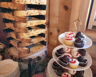 a tower of cupcakes with a stack of plates
