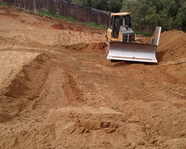 A Bulldozer grading a single family house pad in El Cajon