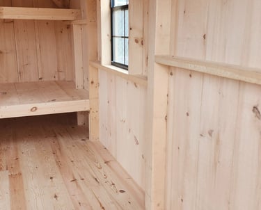 a room with wooden floors and a shelf with shelves